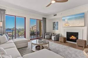 Relax in your elegant living room with cozy fireplace and stunning balcony views.