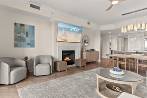 Unwind in your elegant living space with cozy fireplace, modern kitchen, and dining area perfect for memorable evenings together.