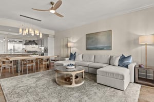 Sink into this plush sectional sofa where coastal blues meet modern comfort, perfect for movie nights in your stylish openplan retreat.