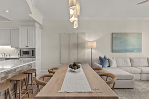 Settle into your openconcept haven where modern coastal style meets comfort. Gather around the dining table or sink into plush seating.