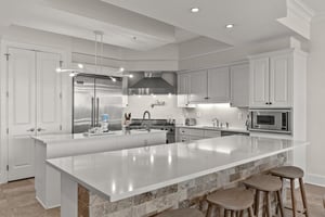 Your gourmet kitchen awaits with gleaming quartz counters, stainless steel appliances, and a spacious island perfect for morning coffee or evening cocktails.