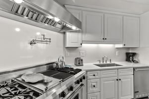 Your fully equipped kitchen features professionalgrade stainless steel appliances and elegant white cabinetry, perfect for preparing memorable meals during your stay.