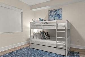 Sleep soundly in this thoughtfully designed bunk room with crisp linens and a cozy trundle bed for extra guests.