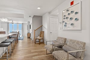 Relax in your bright living space with coastal artwork and stylish seating.