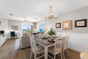 Gather around the dining table with stunning ocean views streaming through the windows, creating perfect moments for memorable meals together.
