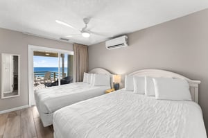 Bedroom 3 offers stunning Gulf views from the comfortable queen beds, with direct balcony access to enjoy morning coffee overlooking the sea.
