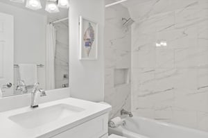 This marble bathroom features a luxurious soaking tub and shower combo.