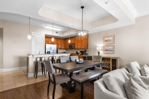 This spacious openconcept haven features a fullyequipped kitchen, elegant dining table, and plush seating for memorable meals together.