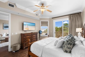 First floor king bedroom with tranquil views from your private balcony, complete with luxurious linens and coastal artwork.
