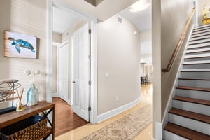 Step into 3119 welcoming entryway where coastal charm meets modern comfort, featuring beautiful hardwood floors and charming nautical touches.