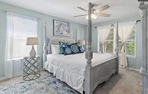 Bedroom 1  Unwind in your elegant fourposter bed beneath a gentle ceiling fan, where coastal blues and crisp linens create the perfect retreat.