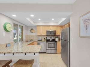 Your fullyequipped kitchen awaits with granite counters, stainless appliances, and breakfast bar seating for memorable meals