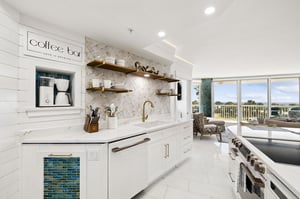 The bright, modern kitchen invites you to brew morning coffee while enjoying peaceful views through expansive windows.