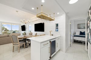 Your bright, elegant kitchen flows into the dining area with stunning ocean views through floortoceiling windows.