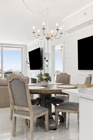 Gather around your elegant dining table where meals become memories, bathed in natural light from large windows.