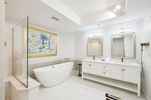 Indulge in your private spalike sanctuary with a freestanding soaking tub, rainfall shower, and elegant dual vanities.