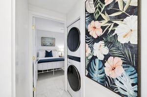 Your laundry day becomes a tropical escape with vibrant botanical art brightening your private washer and dryer space.