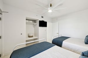Rest easy in your bright twin bedroom with builtin storage and entertainment ready for your stay.