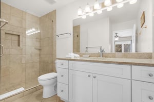 Bathroom 1 features a walkin shower and granite counters