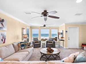 Wake up to breathtaking Gulf views from your comfortable living space, where coastal breezes flow through while you relax on plush seating.