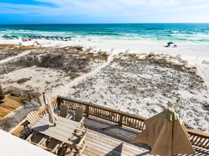 Beachfront property with private deck offering direct access to pristine Gulf waters and white sand dunes.