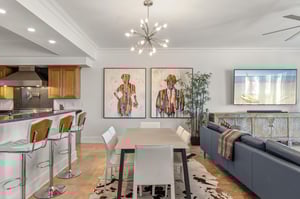 Dine in a modern, open space with a table for 6 and kitchen bar seating for 3.