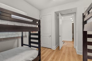 Spacious bunk room for 4 features quality wooden beds with soft linens, perfect for families or groups.