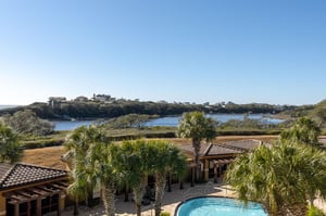 Coastal retreat with lake views and palmlined pool area surrounded by natural wetlands.