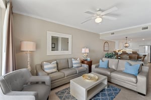 Youll love unwinding in this sophisticated living space, where plush gray sofas and coastal blue accents create your perfect retreat.