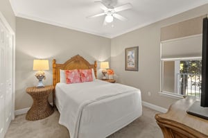 Rest peacefully in the cozy bedroom featuring crisp linens, warm wicker accents, and gentle ceiling fan breezes.