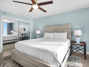 Bedroom 1  Unwind in this serene bedroom with calming blue walls, plush bedding, and a gentle ceiling fan to keep you cool and comfortable.