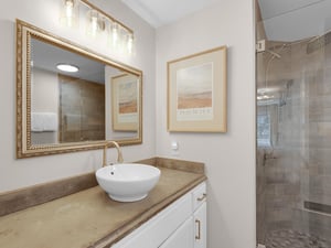 Bathroom 1  Refresh in your beautifully appointed bathroom, where warm lighting and elegant finishes create a spalike atmosphere for your morning routine.
