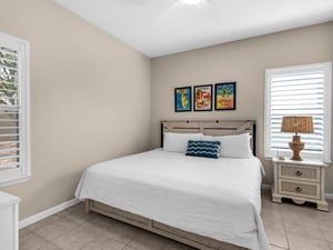 Bedroom 2 Drift into peaceful sleep in your coastalinspired bedroom with crisp linens and charming Florida artwork above the rustic headboard.