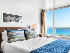 Wake up to stunning Gulf views from Bedroom 1. The panoramic windows frame endless blue waters, creating a serene sanctuary.