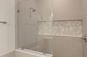 Step into your private spalike shower with elegant glass doors, designer tiling, and a builtin bench for ultimate relaxation.
