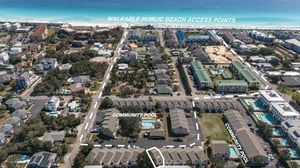 Aerial view of a beachside community with easy access to pristine white sand beaches and community amenities nearby.