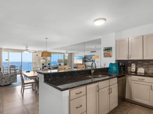 Your fully equipped kitchen opens to stunning ocean views, perfect for preparing meals while watching the waves.