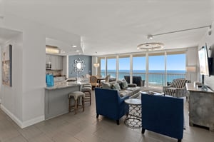 Settle into plush seating while enjoying panoramic ocean views through floortoceiling windows in your elegant coastal retreat.
