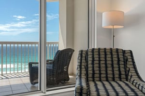 Sink into this comfortable chair and soak up stunning ocean views through your private balcony doors.