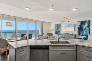 Your open kitchen flows seamlessly into the living area, where ocean views frame every moment of your coastal getaway.