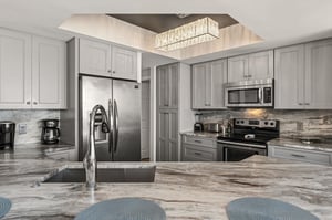 Your gourmet kitchen awaits with granite counters, stainless appliances, and elegant lighting to inspire memorable meals together.