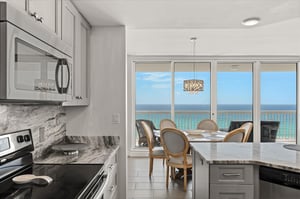 Your kitchen flows seamlessly to dining with stunning ocean views through floortoceiling windows.