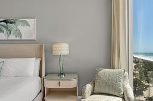 Wake up to stunning ocean views from your elegant bedroom, where crisp linens and coastal artwork create the perfect seaside retreat.