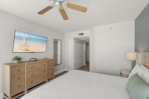 Unwind in your peaceful bedroom where coastal artwork and soft lighting create the perfect atmosphere for restful nights and relaxed mornings.