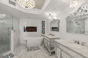 Step into your private spa sanctuary featuring a luxurious soaking tub, elegant marble surfaces, and stunning pendant lighting that creates the perfect ambiance.
