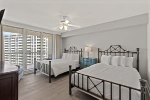 Drift off to sleep in your spacious bedroom with two comfortable beds, city and bay views, and gentle ceiling fan breezes.