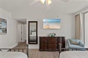 Unwind in your coastalthemed bedroom with ocean artwork and elegant furnishings creating a serene retreat.