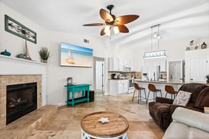 Relax in the bright open living space where coastal decor meets comfort.