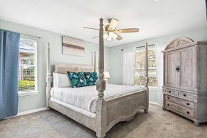 Bedroom 1  Unwind in your elegant fourposter bed beneath a gentle ceiling fan, where coastal blues and crisp linens create the perfect retreat.