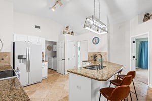 Your spacious kitchen features granite counters, modern appliances, and a breakfast bar where you can sip morning coffee.